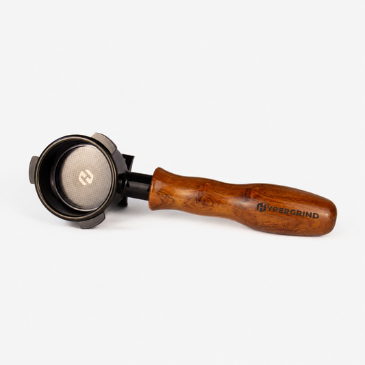 A Hypergrind portafilter with a rich brown wooden handle and a black metal basket, shown on a clean white background.
