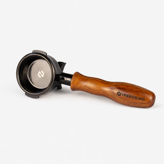 A Hypergrind portafilter with a rich brown wooden handle and a black metal basket, shown on a light gray background.