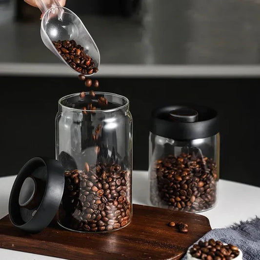 Pouring Coffee Beans into an Airlock Cannister with black lid and valve button.